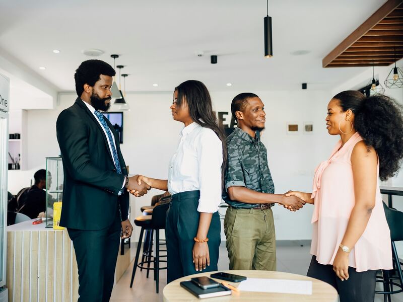 Boomerang representatives shaking hands with business clients in an office
