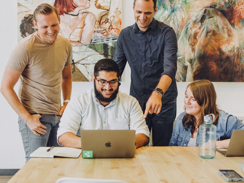 Smiling Boomerang team members collaborating in the office